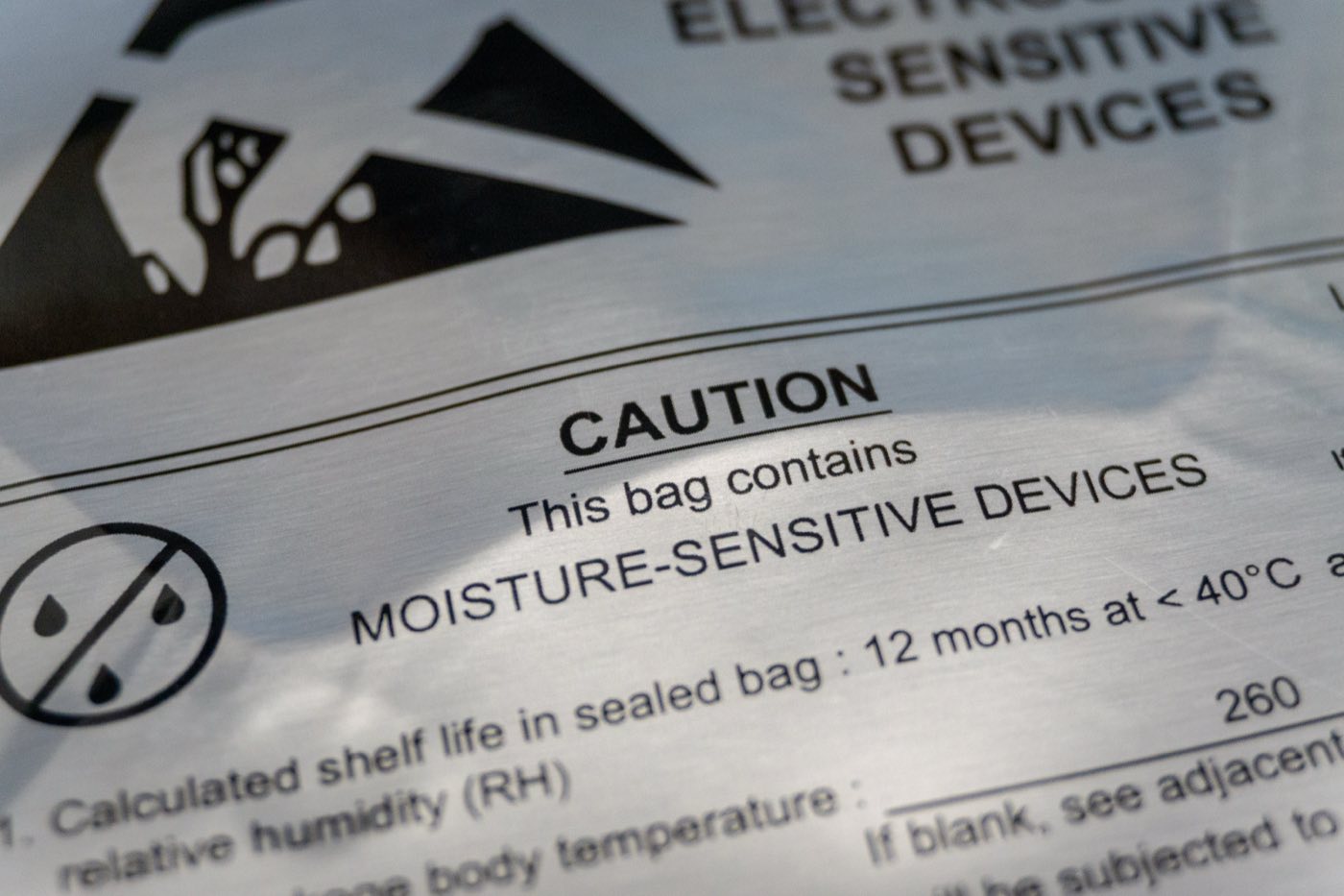 Caution label on a sealed moisture barrier bag warning that it contains moisture-sensitive devices