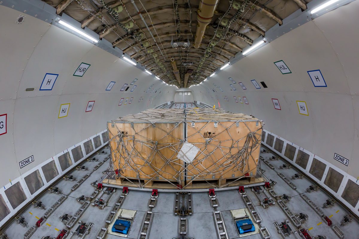 Netted and secured freight crate loaded in the hold of a cargo aircraft