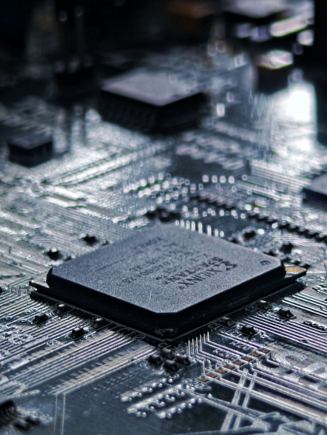 Close-up of an FPGA on a populated circuit board — the kind of component we buy and sell